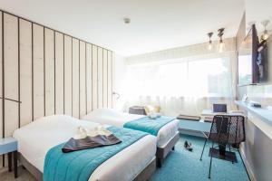 巴拉吕克莱班奥佩拉里亚派斯酒店的一间卧室设有两张床、一张桌子和一个窗口。