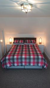 奈恩Seaforth Cottage.的一间卧室配有一张带两盏灯的床。