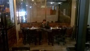瓜杜阿斯Hotel Shalom PHE Guaduas的坐在餐厅桌子上的女人