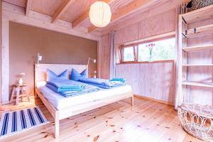 ZempowStudio Zempow, ökologisches Ferienhaus的一间卧室配有一张带蓝色枕头的床。