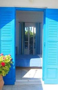 安迪帕罗斯岛Galanis Place的蓝色的客房设有床和窗户。
