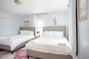 大西洋城9 Bedroom, 14 Beds House Great for Big Groups Near Boardwalk, Tropicana的一间卧室设有两张床和窗户。