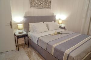 扎金索斯镇Arkadins的一间卧室配有一张大床和两盏灯