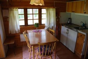 VaggerydLidens Stugby的小屋内的厨房配有桌椅