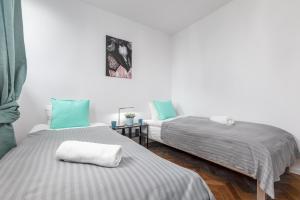 华沙Apartaments Solec 79 by Renters的蓝色和白色的客房内的两张床