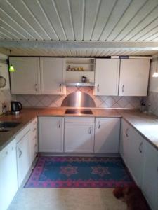 马里博Feriehus stråtækt bindingsværksidyl的一间空厨房,配有白色橱柜和水槽