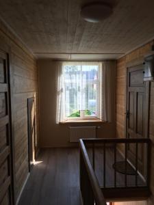 StaiceleKrūmiņmāja的一间空房间,有窗户和楼梯