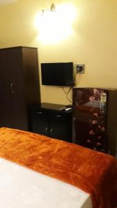 马焦茹达C Pearl的一间卧室配有一张床和一台平面电视