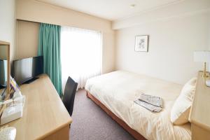 AkishimaStationHotel TOKYO客房内的一张或多张床位