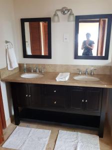 维约堡Emerald Vista Villa的画着带两个盥洗盆的浴室的人