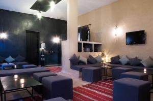 瓦尔扎扎特达查玛酒店的客厅配有蓝色的沙发和电视