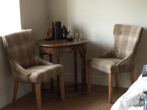 Little MassinghamHill Farm Bed and Breakfast的小桌子,两把椅子,桌子,桌子