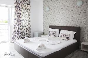科斯蒂内什蒂Anacris Guesthouse的一间卧室配有带白色床单和枕头的床。