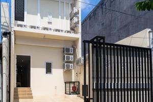 雅加达RedDoorz near Tarumanagara University的前面有黑色门的白色建筑