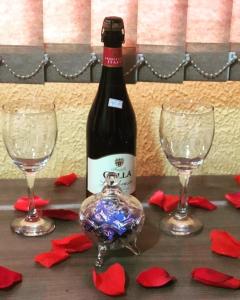 戈亚尼亚POUSADA EXECUTIVE EXPRESS的桌子上放有一瓶葡萄酒和两杯酒