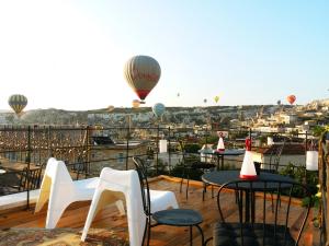 格雷梅卡拉杜特凯芙酒店的一个带桌椅和热气球的甲板