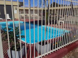 布罗肯希尔沙漠汽车旅馆的一座游泳池,穿过建筑的围栏
