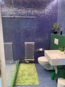 纳沙泰尔3-bedroom apartment with spectacular view的一间带卫生间的浴室和紫色瓷砖墙