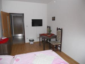 班斯卡-比斯特里察马多娜汽车旅馆的一间卧室配有一张床、一张桌子和一台电视