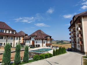 兹拉蒂博尔Zlatibor Hills LARA的享有带游泳池的大楼的正面景色