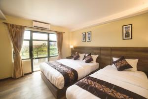 Ganapati Airport Hotel客房内的一张或多张床位