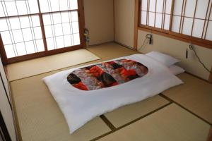 Guesthouse Oyado Iizaka客房内的一张或多张床位