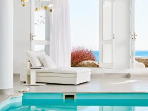 萨鲁Mykonos Blu, Grecotel Boutique Resort的客厅配有白色沙发和窗户