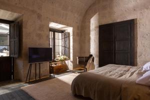 CIRQA - Relais & Châteaux客房内的一张或多张床位