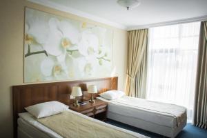 苏尔古特北极星酒店的酒店客房设有两张床和窗户。
