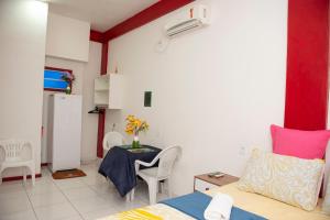 马卡帕Conforto Total - Família Mangas Monteiro的小房间设有一张床和一张桌子及一张桌子