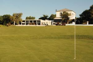 梅塞德斯San Isidro Hotel的绿色的高尔夫球场上悬挂着旗帜