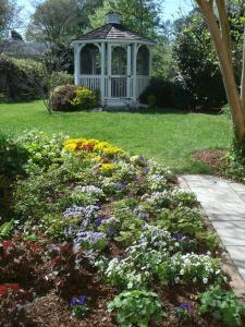 威廉斯堡Newport House Bed & Breakfast的花园中种满鲜花的凉亭
