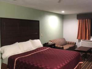 拉夫金德州勒夫套房酒店的配有一张床和一把椅子的酒店客房