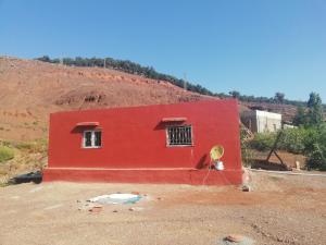 TahlaAuberge de Tabhirte的田间中的一个红色房子