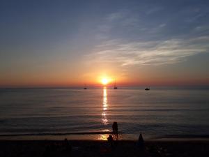 切法卢Cortile Maggiore Home的站在海滩上观看日落的人