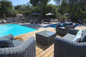 博尼法乔索菲亚公寓酒店的两张带藤椅的游泳池和一个游泳池的图片