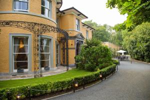 科克Cork's Vienna Woods Hotel & Villas的前面设有花园的大房子