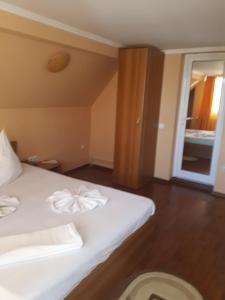 坎皮纳维拉汤姆克里斯酒店的卧室配有白色的床,上面有弓