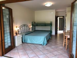 Montefiore dellʼAso帕特里齐亚度假屋的卧室配有1张床,铺有瓷砖地板。