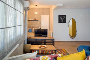 约阿尼纳La Casa - traditionally elegant apt 38m2 w prk grd的客厅配有桌子和冲浪板。