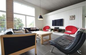 埃贝尔托夫特Nice Home In Ebeltoft With Wifi的客厅配有红色椅子和电视
