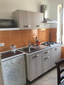 伊斯基亚Casette sul Porto的厨房配有水槽和炉灶
