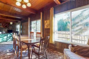 谢弗湖Pond View Lodge的一间带桌椅和窗户的用餐室