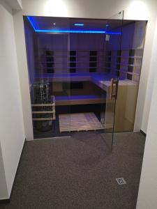 温特贝格Hotel Clemens的紫色灯的玻璃淋浴间