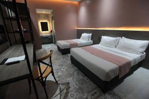 科隆Zenvea Hotel的酒店客房设有两张床和梯子