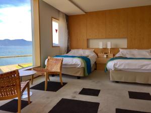 Oi乌敏匹亚酒店的一间带两张床的卧室,享有海景