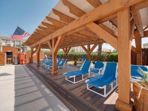 南帕诸岛Relaxing Condo, Great Location, 3 Minute Walk To The Beach Condo的木制甲板上的一组蓝色椅子