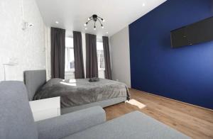圣彼得堡Апарт-Невский 112的一间卧室设有一张床和蓝色的墙壁