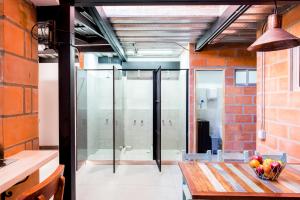 麦德林Medellin Backpacker Hostel的一间设有桌子和玻璃门的房间