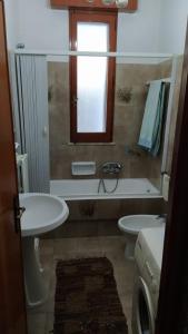 拉卡莱Casa Della Nonna的一间带水槽和卫生间的浴室以及窗户。